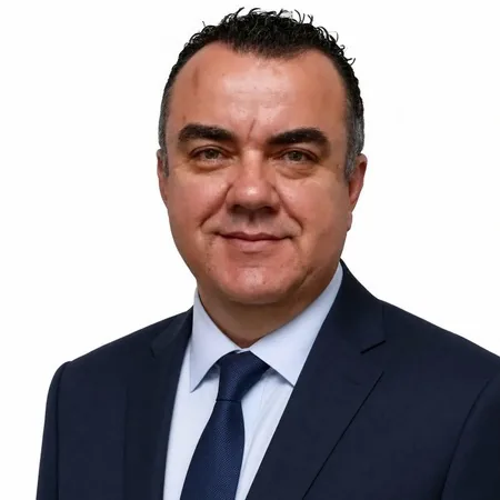 A business professional, Stuart Newman, smiles for a portrait on the AHEG website.