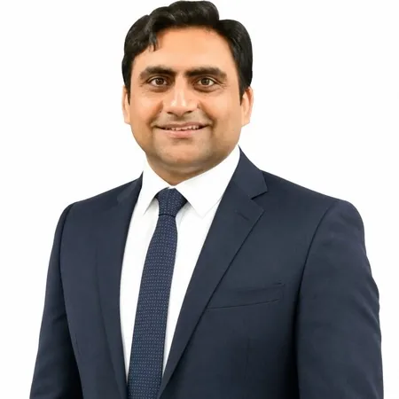 Sukh Sandhu, a business professional smiling at the camera.